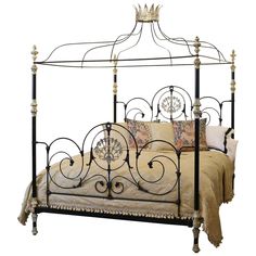 an iron bed frame with a clock on it