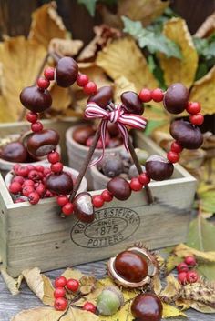 two wooden boxes filled with red berries and chocolate candies on top of each other