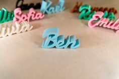 the word beh spelled with plastic letters in different colors on a white table top