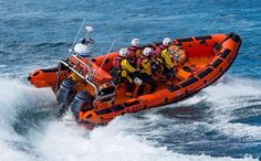 an inflatable boat with several people riding on it's back and side