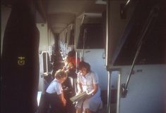 several people are standing on the inside of a bus