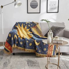 a living room with a couch, coffee table and pictures on the wall above it