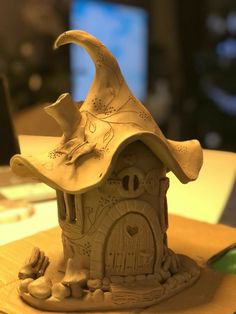 a clay model of a witch's house on a table