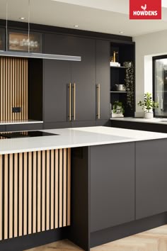 a modern kitchen with black cabinets and white counter tops is featured in the magazine howdens