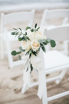 a bouquet of white flowers sitting on top of a chair