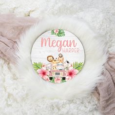 a white fur rug with a pink and green sign that says megan harder on it