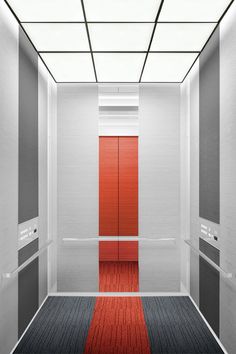 an empty room with red and grey doors