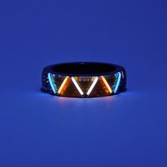 Looking for a unique and futuristic accessory that will make you stand out from the crowd? Check out this amazing ring I have originally designed and made with glow vials that could glow for as long as 25 years which features a cyberpunk or sci-fi style. The vials and electronic components are sealed by resin. So, it is water-proof and super durable in case goes through a severe crash or strike.  This ring is a perfect gift for yourself or someone special who loves glowing gadgets and geeky fashion. 💫 Please note that this is the standard version goes with 2 vials.  Vial colors and pattern can be customized: +$50 for each extra vial. +$30 for a custom pattern. Optional Colors: Green, Blue, Ice Blue, Red, Pink, White, Orange, Yellow and Purple. Band Material: Silver. Width: 6.5mm If you li Futuristic Ring Design, Tech Rings, Cyberpunk Accessories, Futuristic Accessories, Glow Ring, Geeky Fashion, Make It Through, Water Proof, Ice Blue