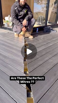 a man kneeling down on top of a wooden deck