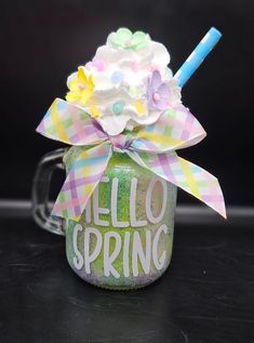 a glass jar filled with whipped cream and flowers