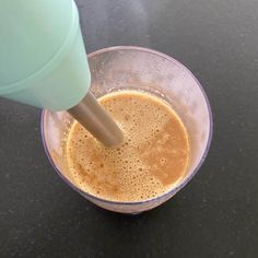 a blender filled with liquid on top of a table