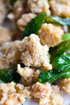 some food is on a white plate with green peppers and breaded crumbs