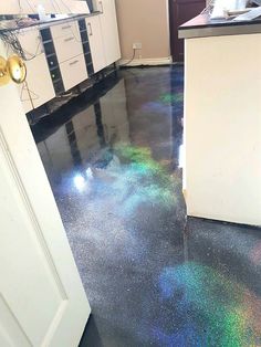 a kitchen floor that is shiny and has some colored flakes on the ground next to it