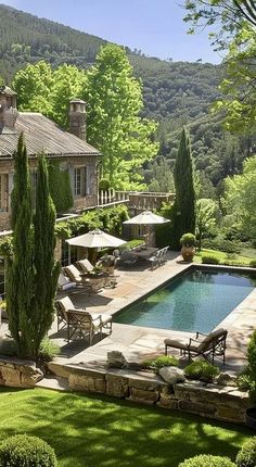 an outdoor swimming pool surrounded by lush green trees