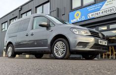 a grey van parked in front of a building