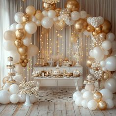 a white and gold dessert table with balloons