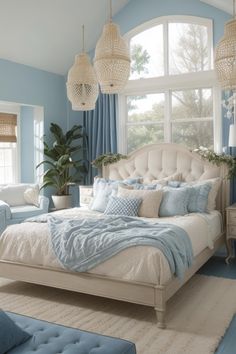 a bedroom with blue walls and white furniture