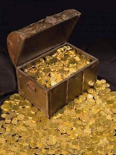 a chest full of gold coins on a black background