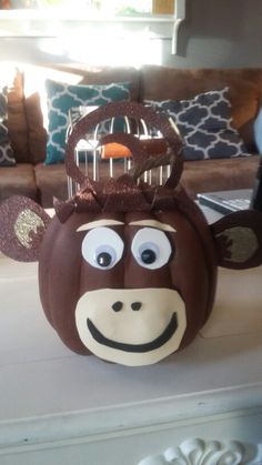 a pumpkin decorated like a monkey with a crown on it's head and eyes