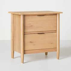 a wooden cabinet with two drawers on one side and an open drawer on the other