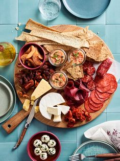 a platter filled with meats, cheese and crackers