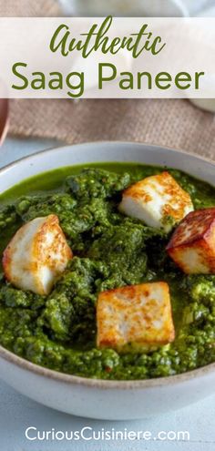 a white bowl filled with green soup and sea scallops