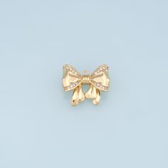 an image of a bow brooch on a light blue backgrounge background