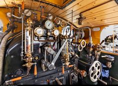 the inside of an old steam engine with gauges, valves and other mechanical equipment