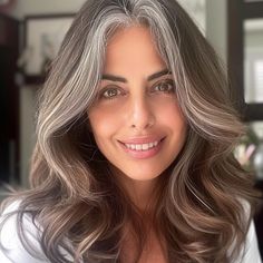 25 Best Hair Colors for Gray Hair, According to Experts Blend Greys In Dark Hair, Brunette Hair Going Grey, Ash Gray Hair Color For Morena, Brunette Gray Hair, Hair Color Ideas To Blend Grey Hair, Warm Gray Hair Color, Grey Hair Blending Brunette, Dark Hair Gray Blending, Gray Blending Brown Hair