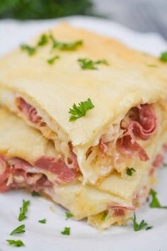 a close up of a plate of food with meat and cheese