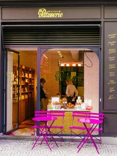 two tables and chairs in front of a storefront with the door open to it