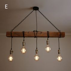 five light bulbs hanging from a wooden beam