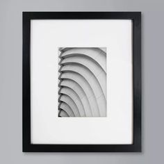 a black and white photo in a frame on the wall with an abstract pattern inside