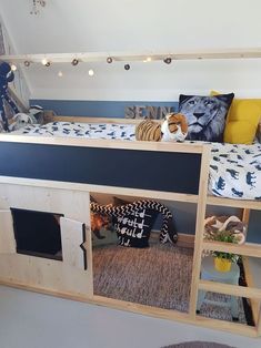 there is a bunk bed that has been built into the wall with shelves underneath it