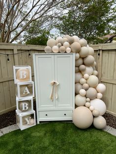 an outdoor baby shower is decorated with balloons