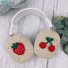 two crocheted strawberry purses sitting on top of a table