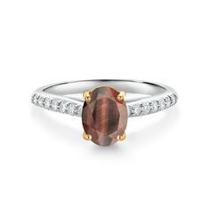 a white gold ring with a brown stone and diamonds on the sides, set in 18k yellow gold