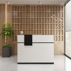 a white reception desk in front of a wall with wooden paneling and potted plants