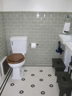 a white toilet sitting next to a sink in a bathroom