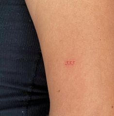 a woman's arm with a small tattoo on the left side of her body