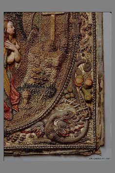 an intricately designed tapestry with a woman holding a bird in her arms and the image is on display