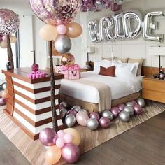 a bedroom decorated with balloons and streamers for a bridal party or birthday celebration