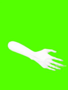 a white plastic hand on a green background