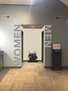 an open door leading to a women's room with a sign on the wall