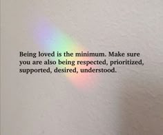 a rainbow colored light shining down on a white wall with the words being loved is the maximum make sure you are also being respected