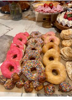 a table topped with lots of donuts covered in sprinkles