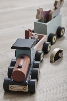 a small wooden toy train on the floor