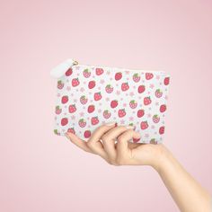 This compact Strawberries and Daisies Mini Clutch Bag is perfect for holding all your essentials on the go. Its cute and pretty design adds a touch of style to any outfit. With this handy bag, you can keep your belongings organized and easily accessible. Designed to be chic and highly portable, this mini clutch bag is made for anyone on the go. It can hold everyday essentials such as a phone, a wallet, and keys. It features a zip fastener and it is made of vegan, cruelty-free leather. .: Material: 100% polyurethane faux leather .: Double-sided print with Saffiano pattern finish.: One compartment for cash, cards, other small items.: Black lining.: Metal zipper closure 6.3” x 4” Width, in 6.30 Height, in 4.02 Depth, in 0.31 Trendy White Pouch For School, Trendy White School Pouch, White Pouch Pencil Case For Daily Use, Pink Strawberry Print Bag As Gift, Cute Rectangular Cosmetic Bag For Everyday Use, Trendy Cosmetic Bag With Mobile Phone Holder As Gift, Trendy White Pouch For Personal Use, White Portable Cosmetic Bag Gift, Trendy White Rectangular Cosmetic Bag