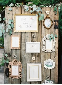 a wooden wall with pictures and frames on it