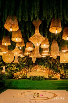 the lights are hanging from the ceiling above the dance floor in this garden party setting